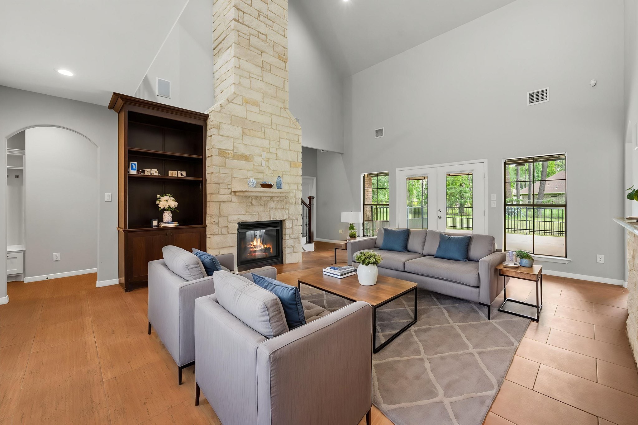 Professionally photographed living room with stone fireplace