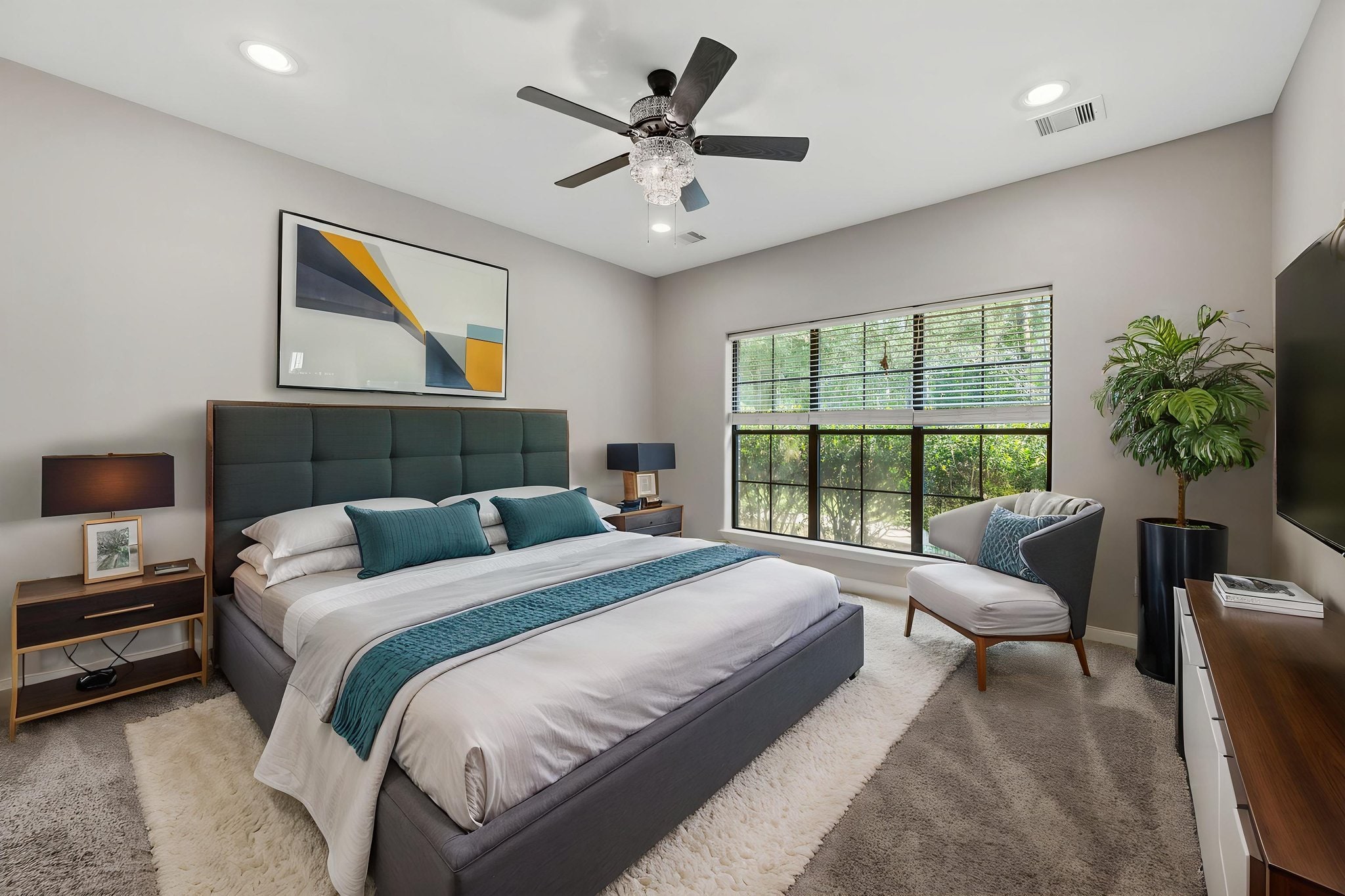 Professionally photographed primary bedroom in a refined neutral palette