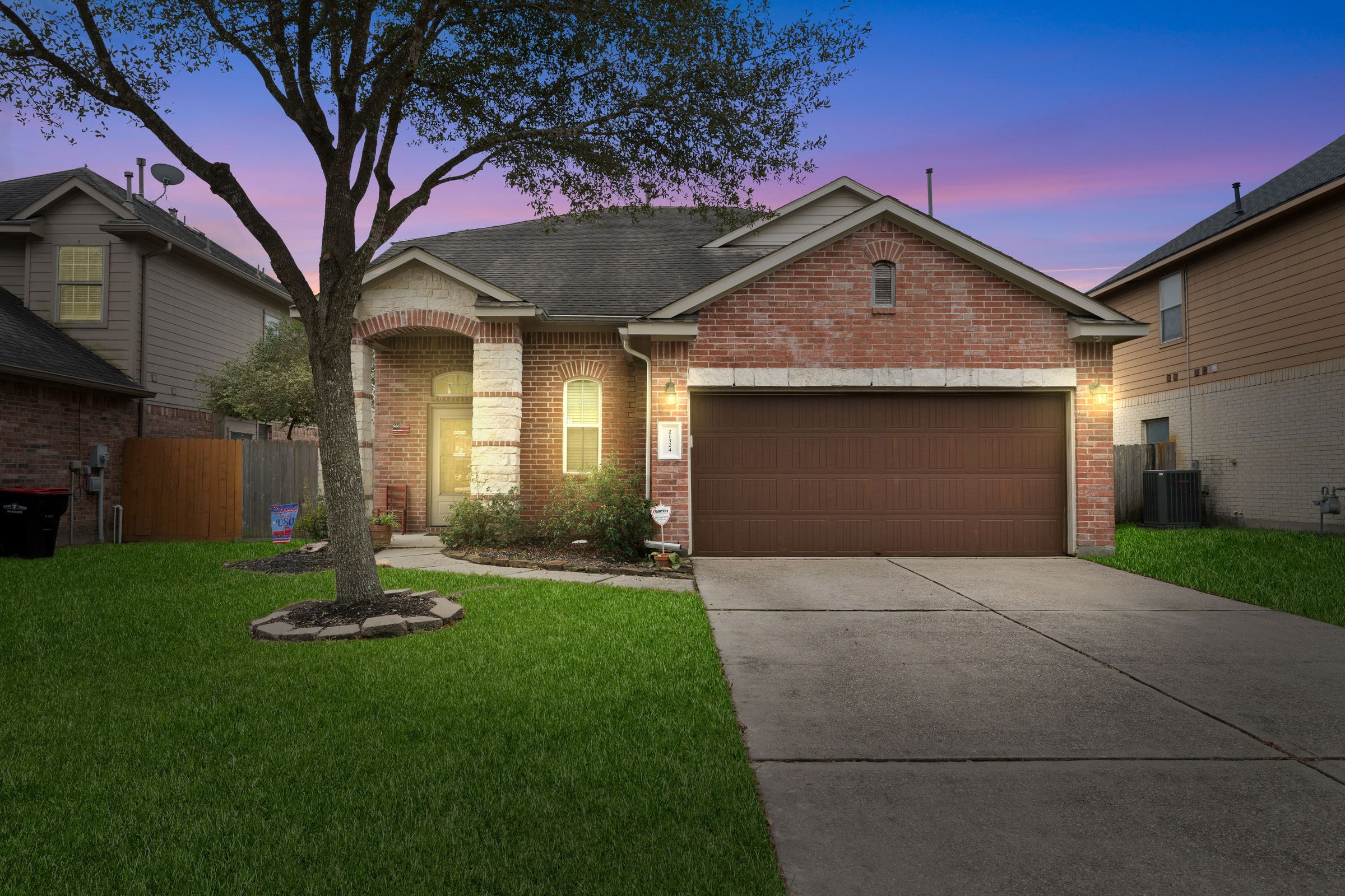 Twilight exterior of a brick single-story home